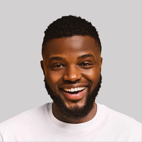 Smiling man in a white t-shirt sharing his successful driving test experience.