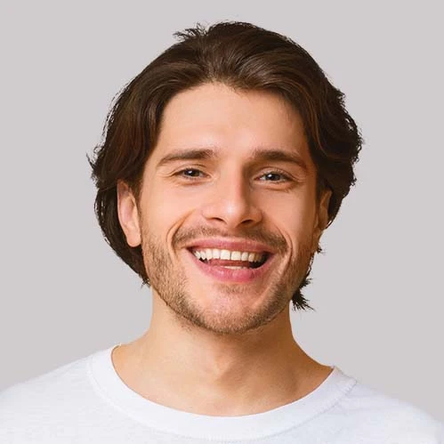 Smiling man in a white t-shirt sharing his successful driving test experience.